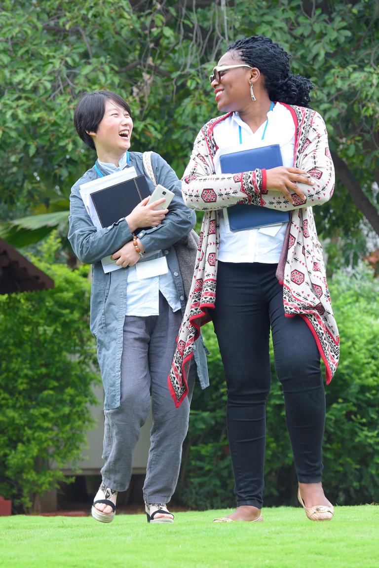 Two people walking and laughing together