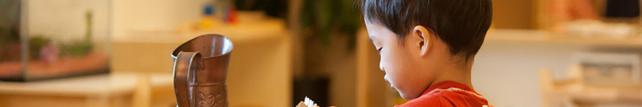 Child hand washing in a Montessori classroom