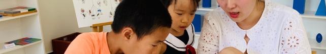 Elementary guide and children discussing document